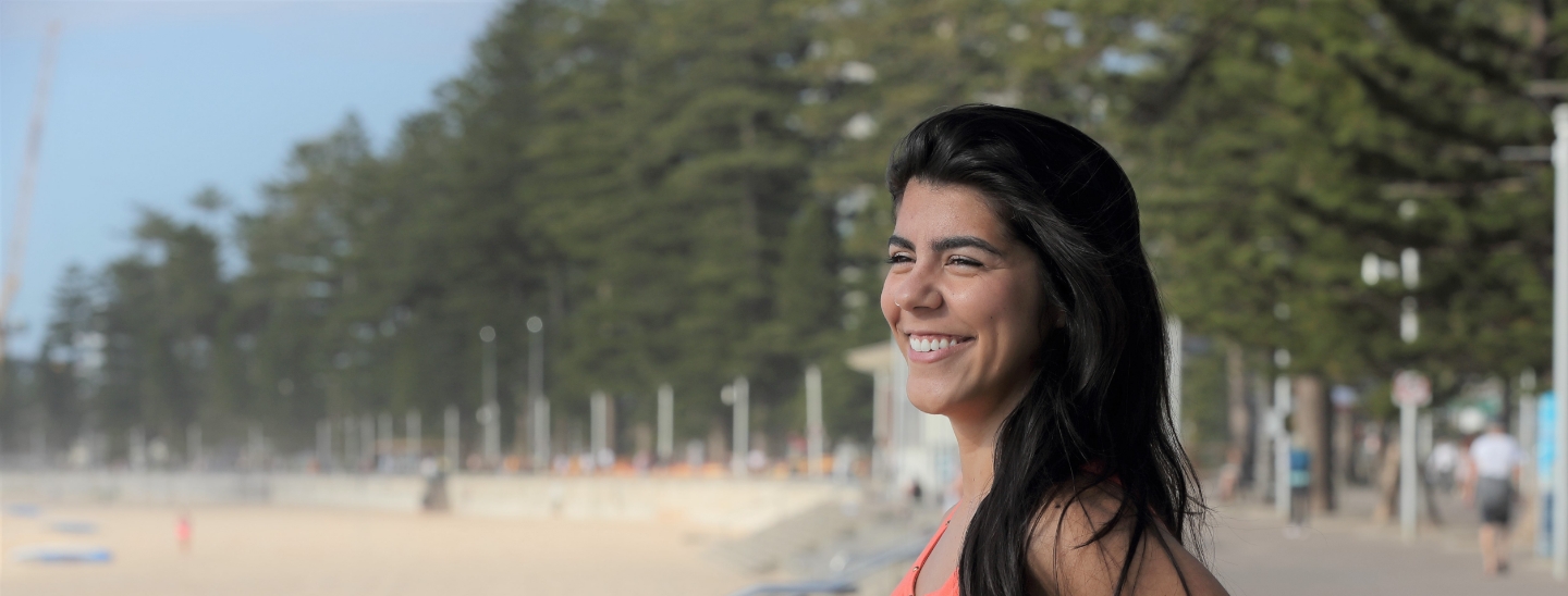 Student on beach happy