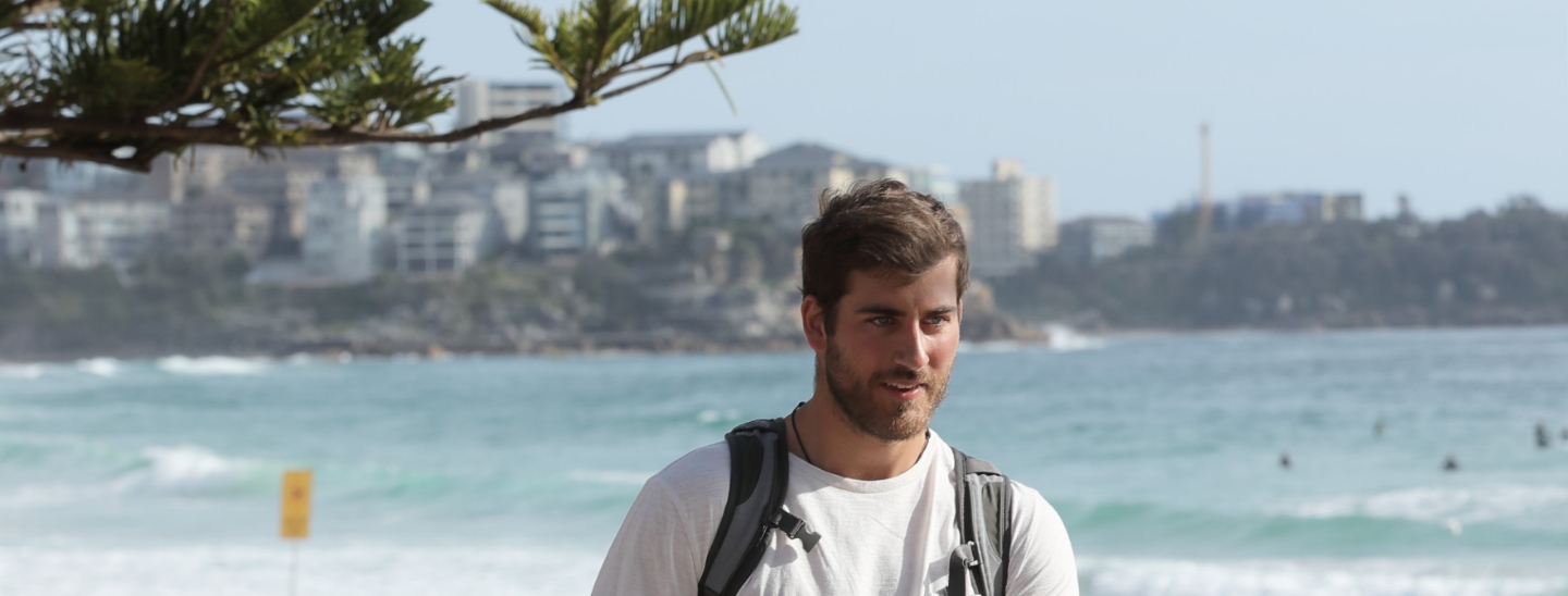 Student outside sydney beach