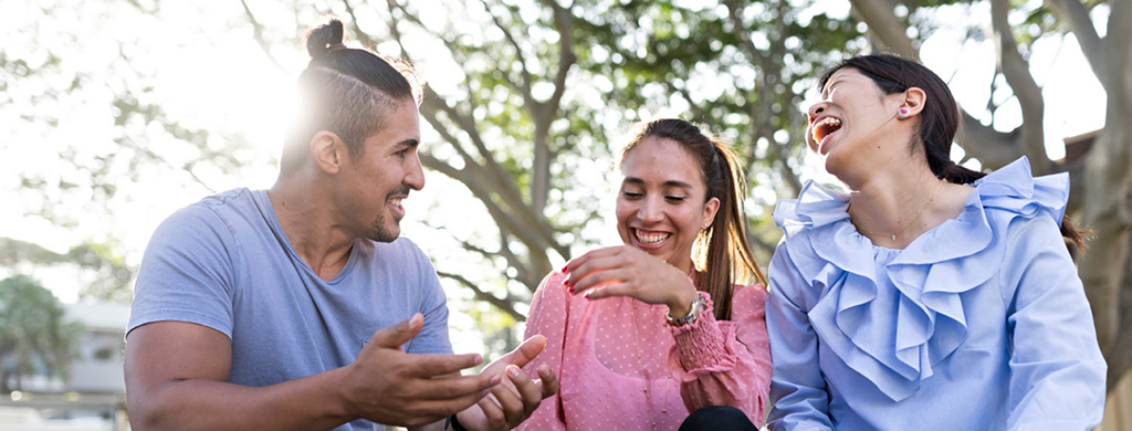 Students happy sitting outside together