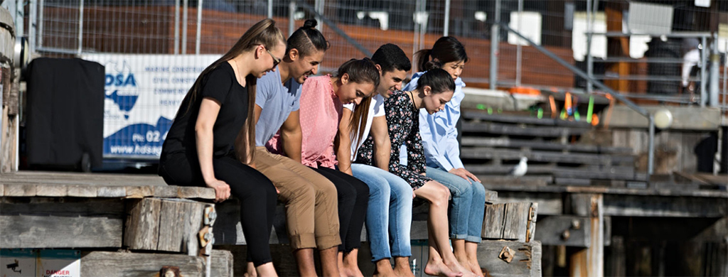 Students sitting on jetty